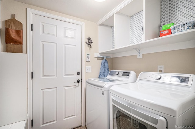 clothes washing area with separate washer and dryer