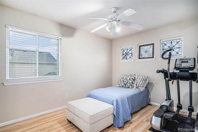 bedroom with light hardwood / wood-style flooring and ceiling fan