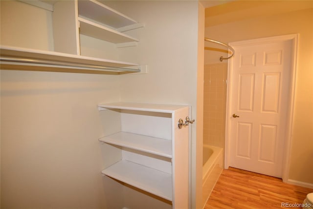 spacious closet with light hardwood / wood-style floors