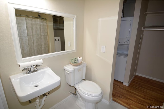 bathroom with wood finished floors, a sink, toilet, and baseboards