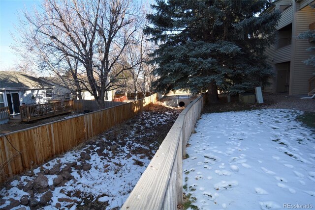 yard covered in snow featuring a fenced backyard