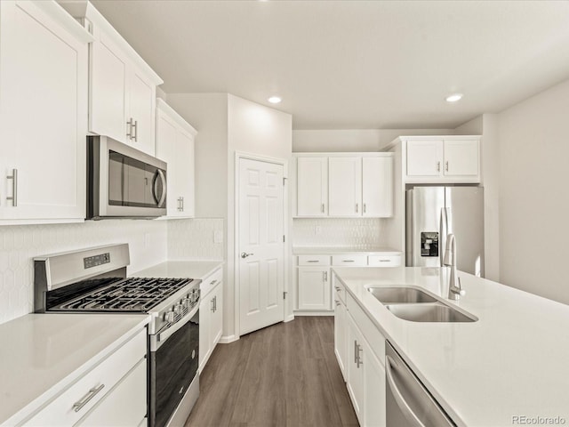 kitchen featuring dark hardwood / wood-style floors, white cabinetry, sink, and appliances with stainless steel finishes