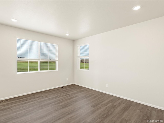 unfurnished room featuring dark hardwood / wood-style flooring