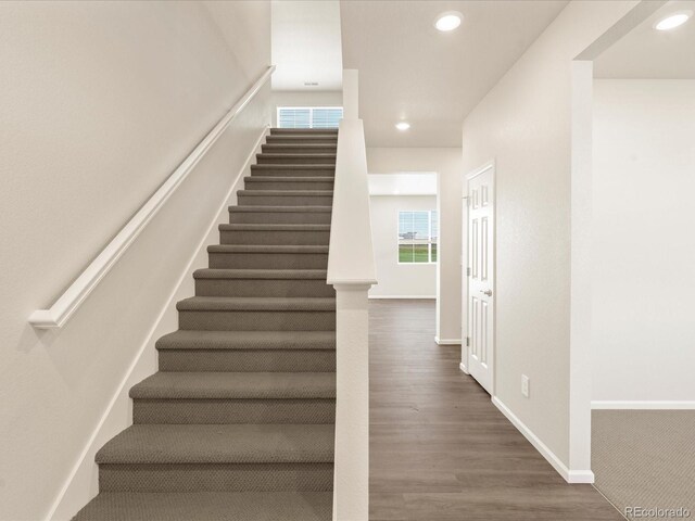 stairs with hardwood / wood-style flooring