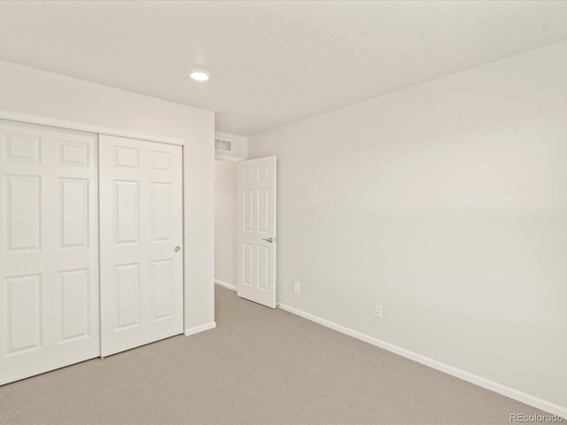 unfurnished bedroom with carpet flooring and a closet