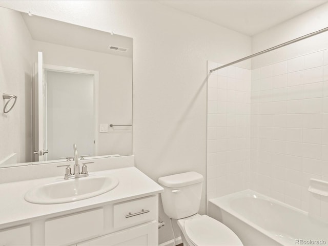 full bathroom featuring washtub / shower combination, vanity, and toilet