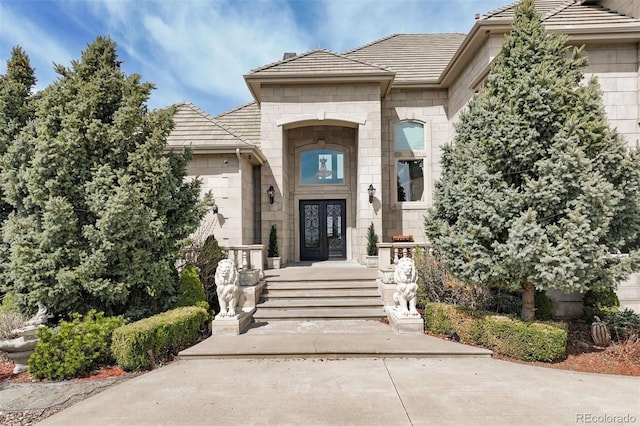 7615 Lemon Gulch Way, Castle Rock, CO 80108 - doorway to property featuring french doors and stone siding