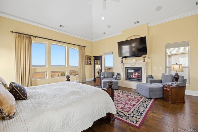 7615 Lemon Gulch Way, Castle Rock, CO 80108 - bedroom with a glass covered fireplace, wood-type flooring, baseboards, crown molding, and high vaulted ceiling