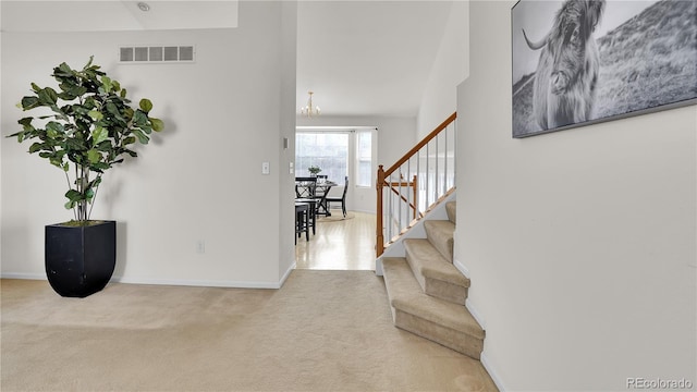 interior space featuring a chandelier and light carpet