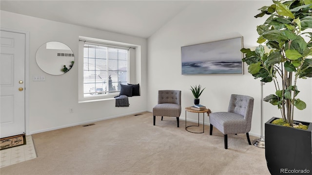 sitting room featuring vaulted ceiling and light carpet