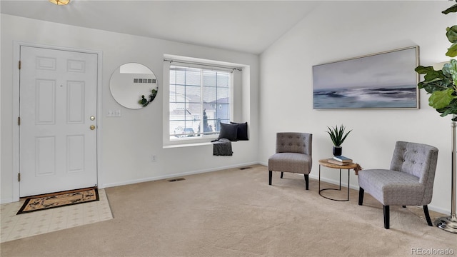 entrance foyer featuring light colored carpet and lofted ceiling