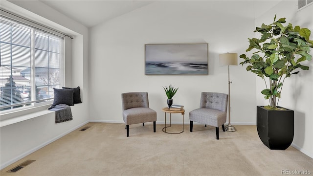 sitting room with light carpet and lofted ceiling