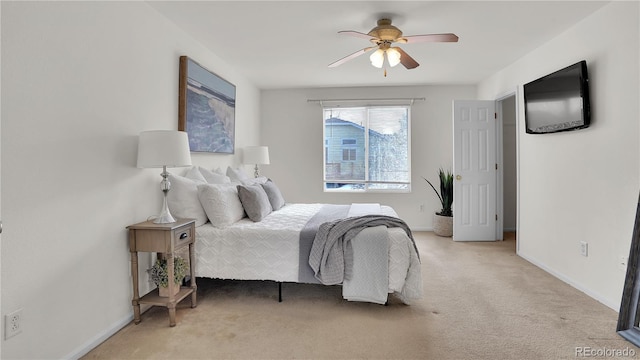 bedroom featuring light colored carpet and ceiling fan