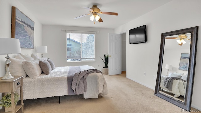 bedroom with ceiling fan and light carpet