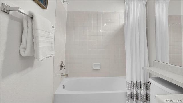 bathroom with shower / bathtub combination with curtain and toilet