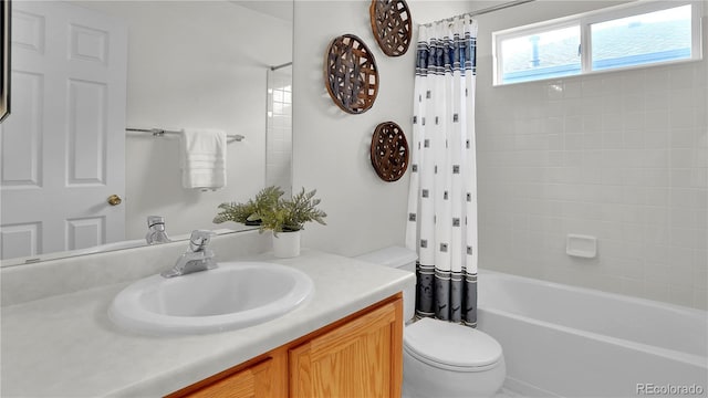 full bathroom featuring vanity, shower / tub combo with curtain, and toilet