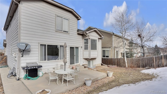 snow covered house with a patio