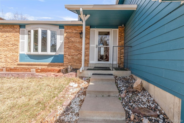 entrance to property with brick siding