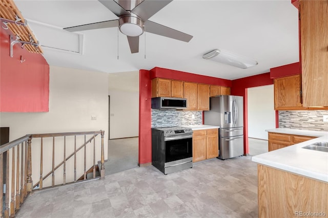 kitchen with backsplash, appliances with stainless steel finishes, and light countertops