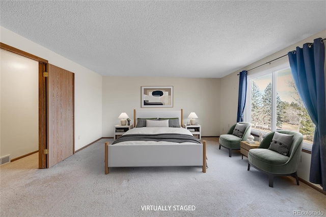 bedroom with visible vents, baseboards, carpet, and a textured ceiling