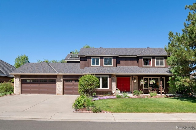 view of front facade featuring a garage, driveway, a front lawn, and brick siding