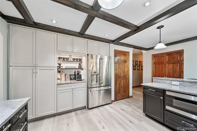 kitchen with appliances with stainless steel finishes, beam ceiling, light wood-type flooring, hanging light fixtures, and recessed lighting