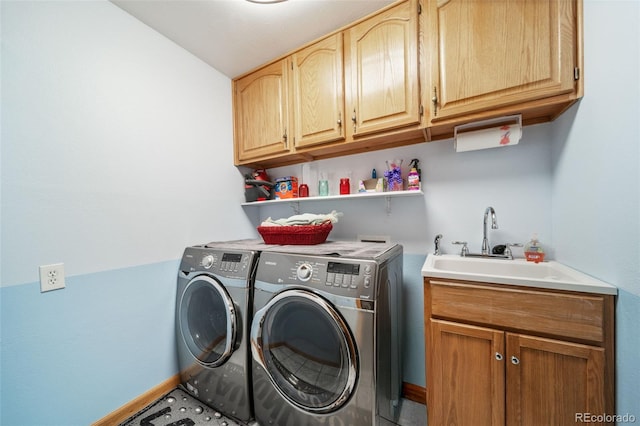 clothes washing area featuring washer and dryer and cabinet space