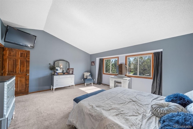carpeted bedroom with vaulted ceiling and a textured ceiling