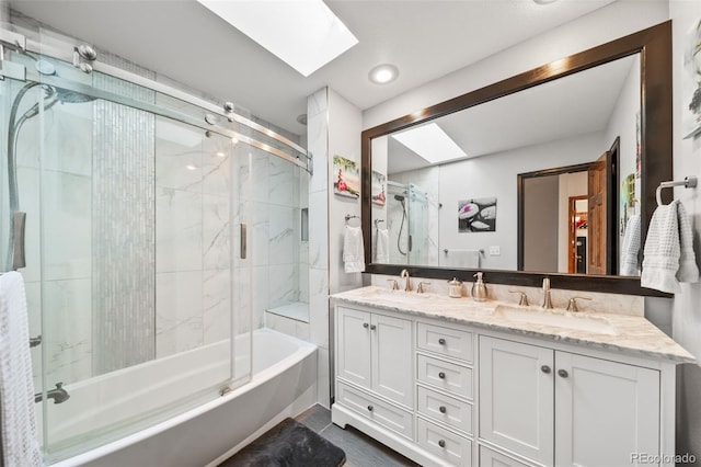 full bathroom with a skylight, double vanity, and combined bath / shower with glass door