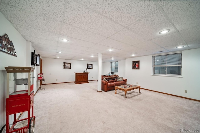 living room with light colored carpet, baseboards, recessed lighting, and a drop ceiling