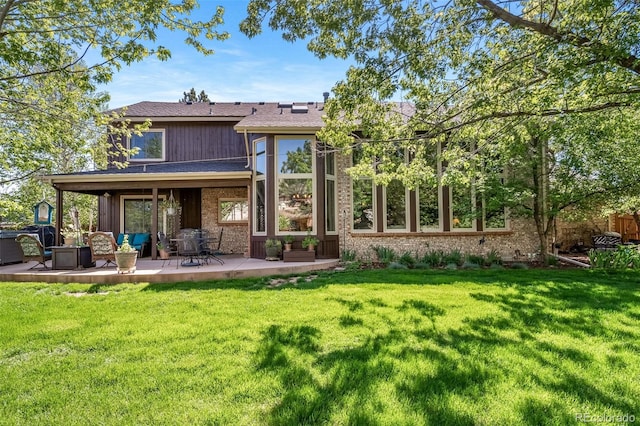 back of property featuring a patio and a lawn