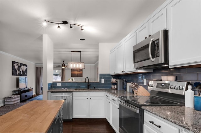 kitchen featuring white cabinetry, a sink, backsplash, and stainless steel appliances
