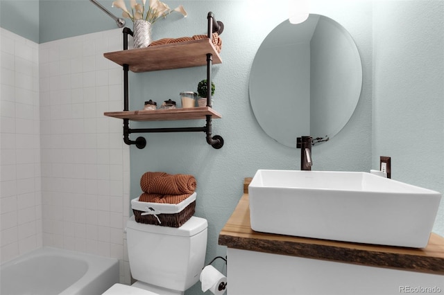 bathroom featuring a textured wall,  shower combination, a sink, and toilet