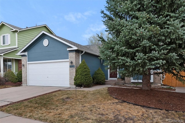 view of front of house featuring brick siding, entry steps, driveway, and a garage