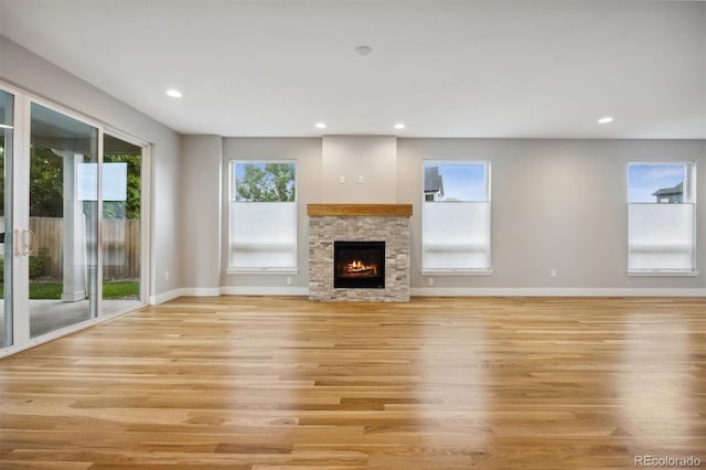 unfurnished living room with a fireplace and light hardwood / wood-style flooring