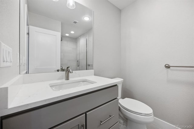 bathroom with vanity, toilet, and an enclosed shower