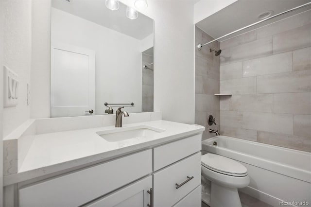 full bathroom featuring toilet, vanity, and tiled shower / bath