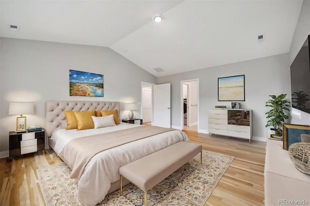 bedroom featuring hardwood / wood-style floors and vaulted ceiling