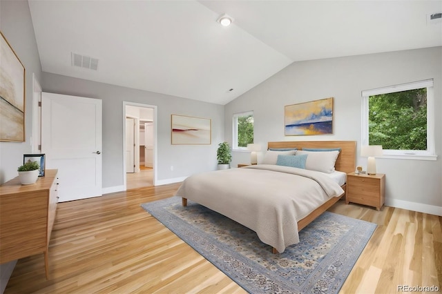 bedroom featuring lofted ceiling and light wood-type flooring