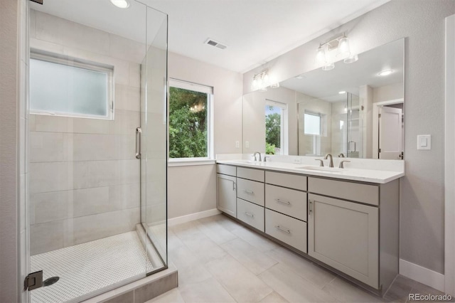 bathroom with a shower with door and vanity