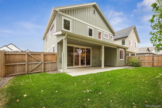 back of house featuring a yard and a patio