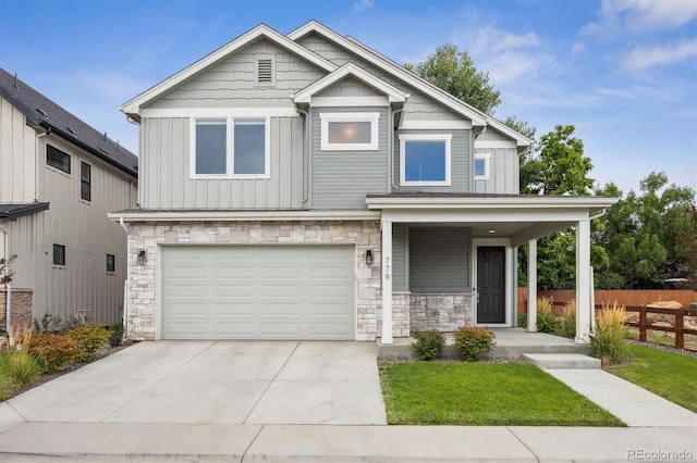 view of front of house featuring board and batten siding, concrete driveway, covered porch, stone siding, and an attached garage