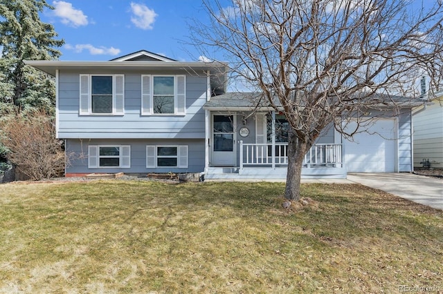 tri-level home with a garage, covered porch, driveway, and a front lawn