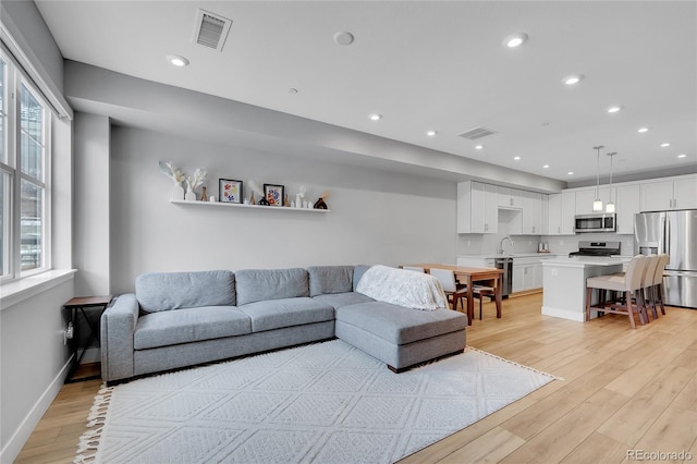 6211 W 28th Ct, Wheat Ridge, CO 80214 - living room featuring light wood-style flooring and recessed lighting