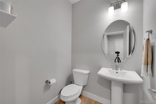 6211 W 28th Ct, Wheat Ridge, CO 80214 - half bath featuring toilet and wood finished floors
