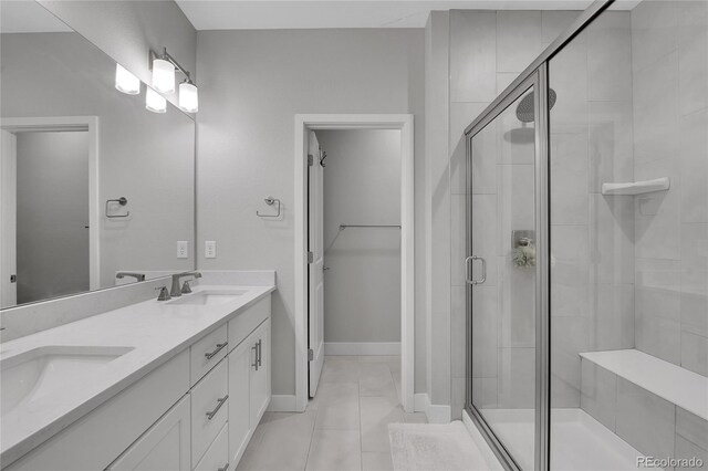 6211 W 28th Ct, Wheat Ridge, CO 80214 - full bath featuring a stall shower, double vanity, tile patterned floors, and a spacious closet