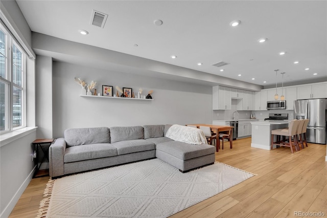 6211 W 28th Ct, Wheat Ridge, CO 80214 - living area featuring light wood-style flooring and recessed lighting