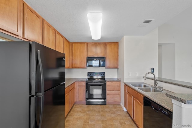 23451 E 5th Dr Unit 203, Aurora, CO 80018 - kitchen featuring black appliances, a sink, and a peninsula