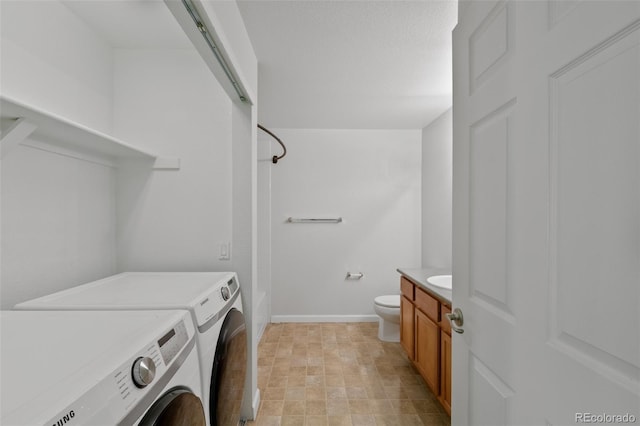 23451 E 5th Dr Unit 203, Aurora, CO 80018 - laundry room with washing machine and dryer and baseboards