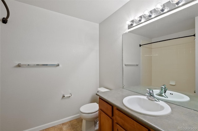 23451 E 5th Dr Unit 203, Aurora, CO 80018 - full bathroom with baseboards, vanity, toilet, and a shower